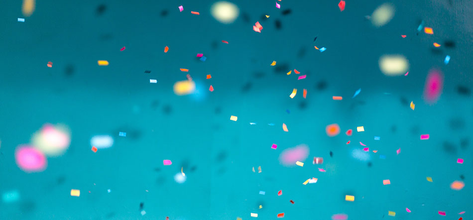 Different Color Confetti Falling In Front Of Teal Background