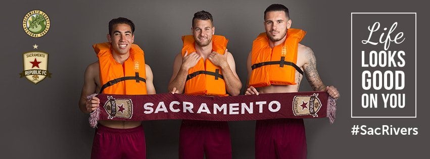 Life Looks Good On You Billboard graphic we made featuring members of the Sac Republic Soccer Team Holding Team Scarf Wearing Lifejackets