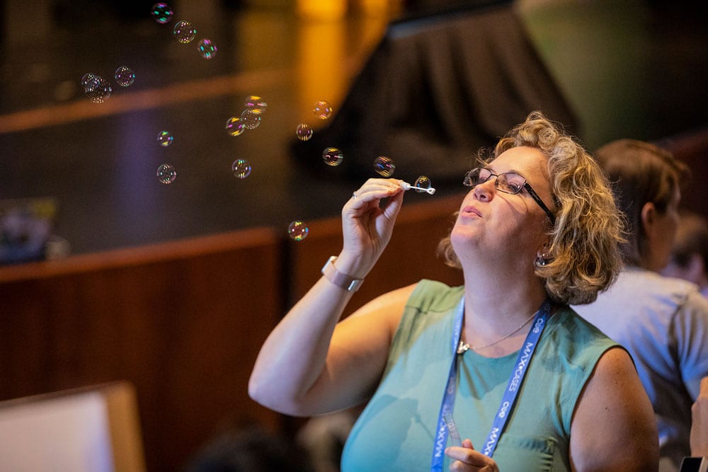 woman blowing bubbles at the conference
