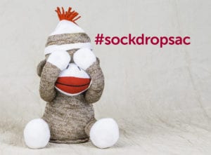 Sock Drop Sac Hastag With Sock Monkey Sitting With Hands Over Its Eyes