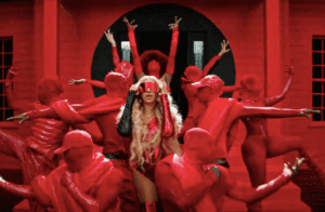 a red tinted image with dancers in the middle